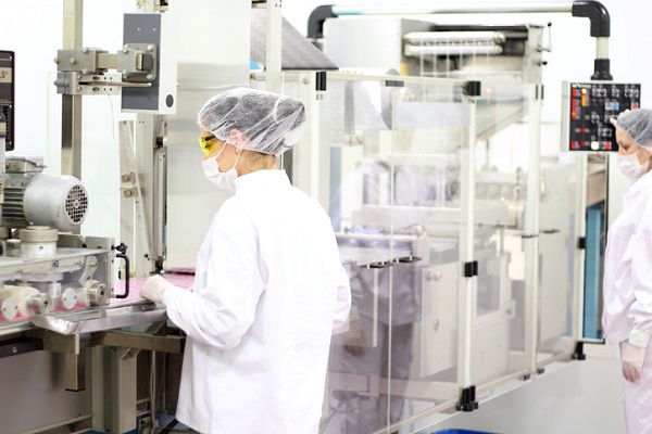 People in protective wear in a manufacturing lab